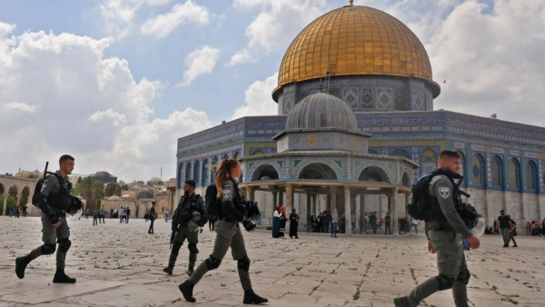 Israeli police walk at the Dome of the Rock mosque