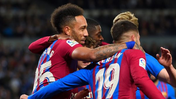 Barcelona's Gabonese midfielder Pierre-Emerick Aubameyang (L) celebrates scoring the opening goal during the Spanish League football match between Real Sociedad and FC Barcelona at the Anoeta stadium in San Sebastian on April 21, 2022. (Photo by ANDER GILLENEA / AFP)