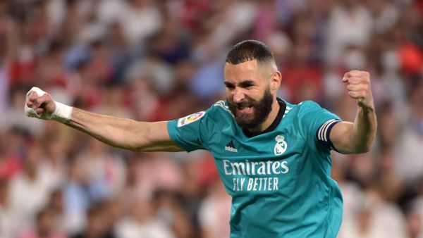 Real Madrid's French forward Karim Benzema celebrates after Real Madrid's Spanish defender Nacho Fernandez scored a goal during the Spanish League football match between Sevilla FC and Real Madrid CF at the Ramon Sanchez Pizjuan stadium in Seville on April 17, 2022. (Photo by CRISTINA QUICLER / AFP)