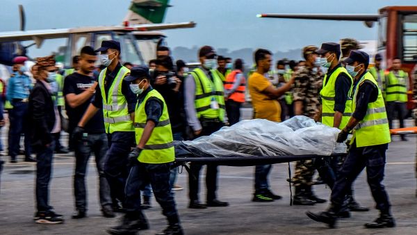 Nepali rescuers have retrieved the bodies of all but one of 22 people on board a plane that crashed into a Himalayan mountainside over the weekend, the army said May 30. (Photo by Bikash Karki / AFP) Missing plane