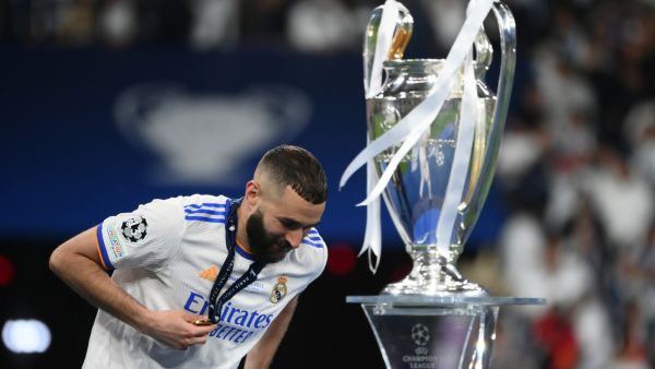 Real Madrid's French forward Karim Benzema walks past the trophy after winning the UEFA Champions League final football match between Liverpool and Real Madrid at the Stade de France in Saint-Denis, north of Paris, on May 28, 2022. (Photo by FRANCK FIFE / AFP)