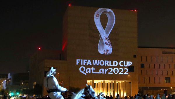 ile photo taken on September 3, 2019, a mounted policeman rides past a building on which the official logo of the FIFA World Cup Qatar 2022 logo is projected at the Qatari capital Doha's traditional Souq Waqif market. Migrant labourers are working through the night near the World Cup clock that will start counting down 200 days to kick-off on May 5, 2022, with hosts Qatar facing mounting questions over costs and conditions for fans. (Photo by AFP)