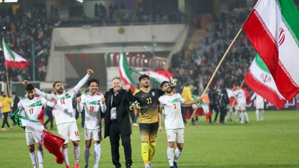 Iran's players celebrate with their fans after qualifying for the 2022 Qatar World Cup after their win against Iraq in the Asian Qualifiers football match at the Azadi Sports Complex in the capital Tehran, on January 27, 2022. (Photo by Atta KENARE / AFP)