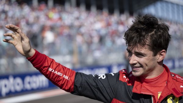 Ferrari's Monegasque driver Charles Leclerc waves to fans after winning the pole position during qualifying for the Miami Formula One Grand Prix at the Miami International Autodrome in Miami Gardens, Florida, on May 7, 2022. (Photo by Brendan Smialowski / POOL / AFP)