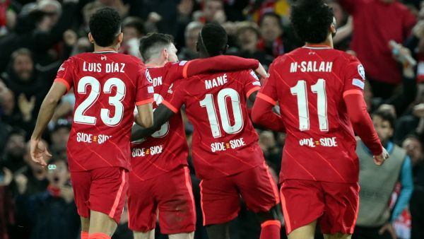 Liverpool's Senegalese striker Sadio Mane celebrates with teammates after scoring his team second goal during the UEFA Champions League semi-final first leg football match between Liverpool and Villarreal, at the Anfield Stadium, in Liverpool, on April 27, 2022. (Photo by LLUIS GENE / AFP)