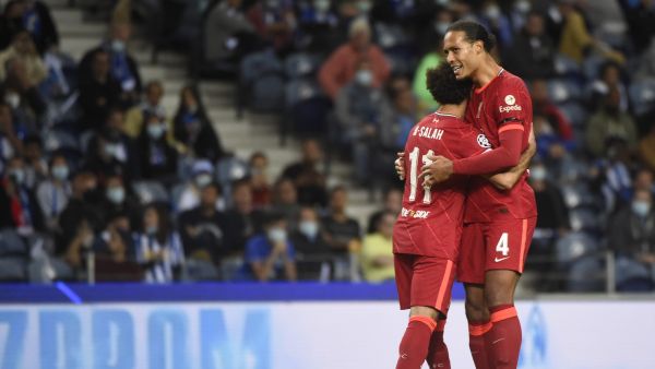 Liverpool's Egyptian forward Mohamed Salah celebrates scoring his team's second goal with Liverpool's Dutch defender Virgil van Dijk during the UEFA Champions League first round group B footbal match between Porto and Liverpool at the Dragao stadium in Porto on September 28, 2021. (Photo by MIGUEL RIOPA / AFP)