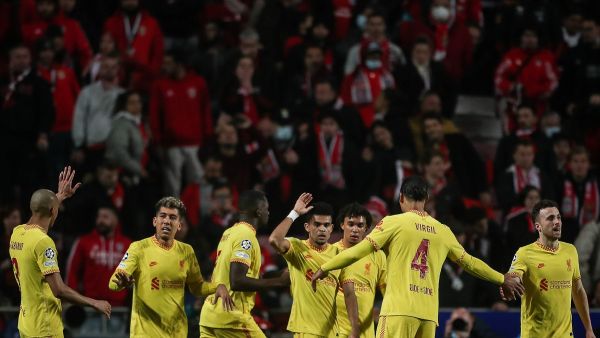 Liverpool's Colombian midfielder Luis Diaz (C) celebrates with teammates after scoring his team's third goal during the UEFA Champions League quarter final first leg football match between SL Benfica and Liverpool FC at the Luz stadium in Lisbon on April 5, 2022. (Photo by CARLOS COSTA / AFP)