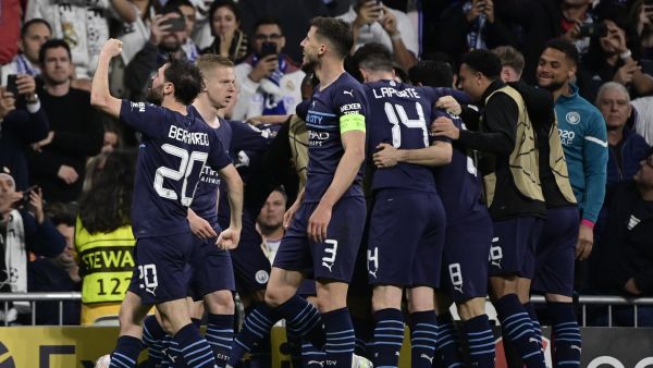 Manchester City players celebrate a goal scored by Manchester City's Algerian midfielder Riyad Mahrez during the UEFA Champions League semi-final second leg football match between Real Madrid CF and Manchester City at the Santiago Bernabeu stadium in Madrid on May 4, 2022. (Photo by JAVIER SORIANO / AFP)