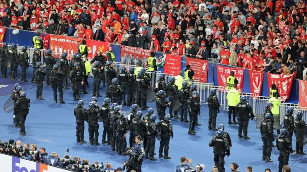 Riot police take up positions in front of the Liverpool fans after the UEFA Champions League final football match between Liverpool and Real Madrid at the Stade de France in Saint-Denis, north of Paris, on May 28, 2022. Real Madrid won the match 0-1. (Photo by Thomas COEX / AFP)