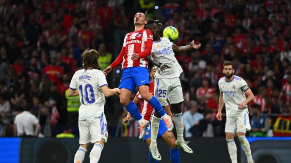 Atletico Madrid's French forward Antoine Griezmann (Top-L) and Real Madrid's French midfielder Eduardo Camavinga (Top-R) jump for the ball during the Spanish League football between Club Atletico de Madrid and Real Madrid CF at the Wanda Metropolitano stadium in Madrid on May 8, 2022. (Photo by GABRIEL BOUYS / AFP)