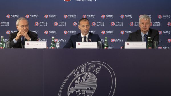 Deputy General Secretary of UEFA, Giorgio Marchetti (left), UEFA president Aleksander Ceferin and Philip Townsend (right) UEFA's managing director of communications, speak during the final press conference at the end of the 46th UEFA Congress and Executive Committee meeting at the Messe Wien Exhibition Congress Center in Vienna, Austria on May 11, 2022. (Photo by JOE KLAMAR / AFP)