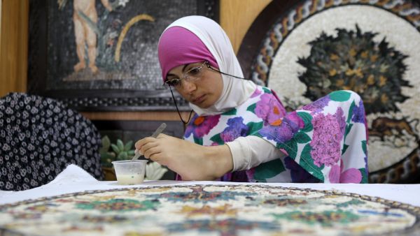 Rahma is an expert on painting Madaba's mosaics