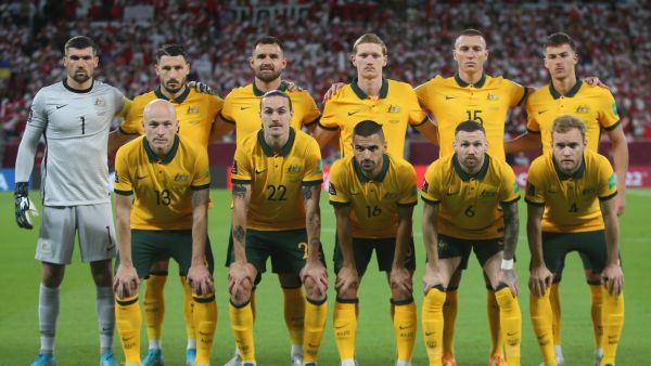 Australia's players pose for a group picture ahead of the FIFA World Cup 2022 inter-confederation play-offs match between Australia and Peru on June 13, 2022, at the Ahmed bin Ali Stadium in the Qatari city of Ar-Rayyan. (Photo by MUSTAFA ABUMUNES / AFP)