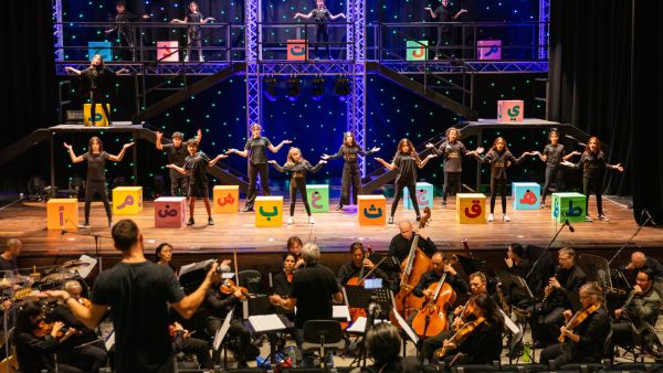 During the event QF Students Prepare to Give Their Musical Showcase Its Stage Debut