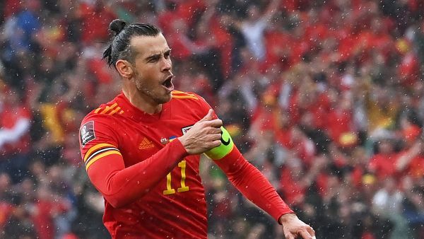  Wales' striker Gareth Bale celebrates after hitting a free kick and Ukraine scoring an own goal opening the score during the FIFA World Cup 2022 play-off final qualifier football match between Wales and Ukraine at the Cardiff City Stadium in Cardiff, south Wales, on June 5, 2022. (Photo by Paul ELLIS / AFP)
