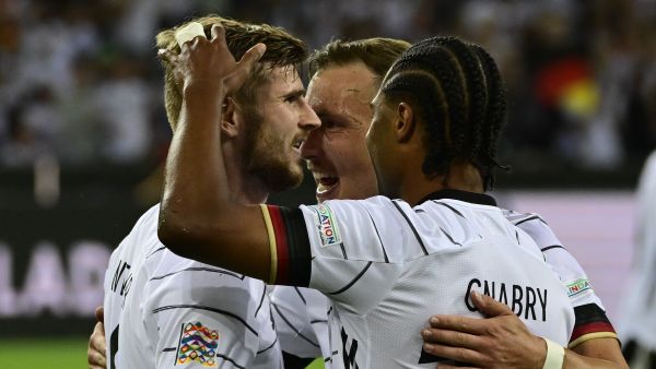 Germany's forward Timo Werner (L) celebrates scoring the 4-0 goal with his teammates during the UEFA Nations League football match Germany v Italy at the Borussia Park stadium in Moenchengladbach, western Germany, on June 14, 2022. (Photo by John MACDOUGALL / AFP)