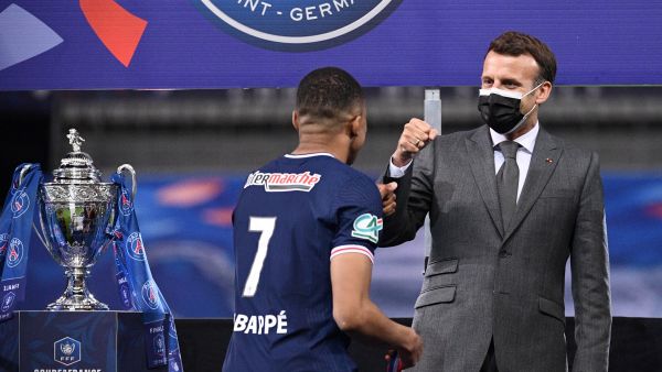 Paris Saint-Germain's French forward Kylian Mbappe is congratulated by French president Emmanuel Macron after winning the French Cup final football match between Paris Saint-Germain and Monaco at the Stade de France stadium, in Saint-Denis, on the outskirts of Paris, on May 19, 2021. / AFP / FRANCK FIFE