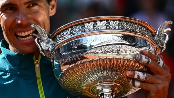 Spain's Rafael Nadal poses with The Musketeers' Cup as he celebrates after victory over Norway's Casper Ruud during their men's singles final match on day fifteen of the Roland-Garros Open tennis tournament at the Court Philippe-Chatrier in Paris on June 5, 2022. (Photo by Anne-Christine POUJOULAT / AFP)