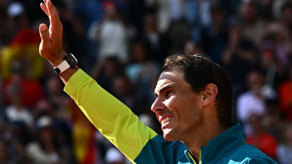 Spain's Rafael Nadal waves as he celebrates after victory over Norway's Casper Ruud during their men's singles final match on day fifteen of the Roland-Garros Open tennis tournament at the Court Philippe-Chatrier in Paris on June 5, 2022. (Photo by Anne-Christine POUJOULAT / AFP)