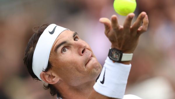 Spain's Rafael Nadal serves to Canada's Felix Auger-Aliassime during their men's exhibition singles match at The Giorgio Armani Tennis Classic tournament at the Hurlingham Club in London on June 24, 2022. (Photo by Adrian DENNIS / AFP)