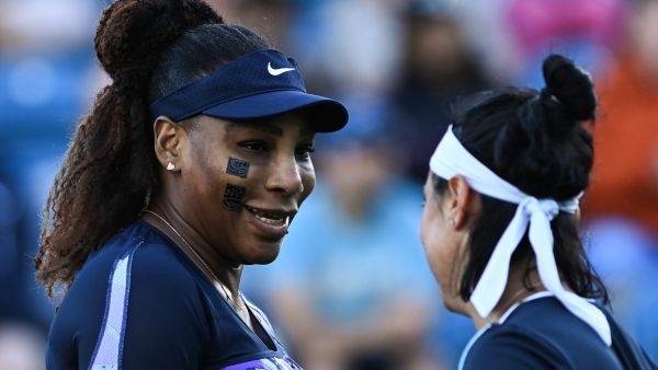 Serena Williams of the US (L) and Tunisia's Ons Jabeur react as they play against Japan's Shuko Aoyama and Taiwan's Chan Hao-ching during their women's doubles quarter final tennis match on day four of the Eastbourne International tennis tournament in Eastbourne, southern England on June 22, 2022. (Photo by Glyn KIRK / AFP)