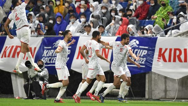 Tunisia's midfielder Mohamed Ali Ben Romdhane (R) celebrates scoring a goal with teammates during the Kirin Cup football final match between Japan and Tunisia at the Panasonic stadium in Suita, Osaka prefecture on June 14, 2022. (Photo by CHARLY TRIBALLEAU / AFP)