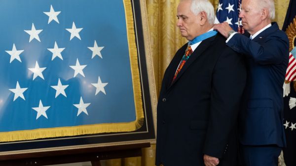 US President Joe Biden awards the Medal of Honor to retired US Army Specialist Five Dwight W. Birdwell for his actions in the Vietnam War, during a ceremony in the East Room of the White House in Washington, DC, July 5, 2022. (Photo by SAUL LOEB / AFP) medal backward