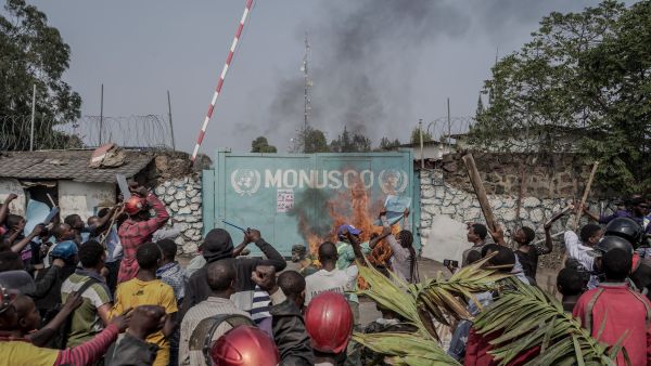 Protesters set fire in front of United Nations Mission for the Stabilisation of Congo (MONUSCO) Headquarters in Goma, on July 25, 2022. (Photo by GLODY MURHABAZI / AFP) Anti-UN protests