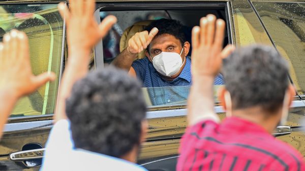 Sri Lanka's main opposition leader Sajith Premadasa waves from a car to supporters during a demonstration to denounce the shortage of cooking gas, sugar, kerosene oil and a few other commodities as the country faces a major foreign exchange crisis, in Colombo on November 16, 2021. (Photo by ISHARA S. KODIKARA / AFP) Sri Lanka