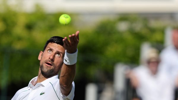 Serbia's Novak Djokovic serves the ball to Canada's Felix Auger-Aliassime during their men's exhibition singles match at The Giorgio Armani Tennis Classic tournament at the Hurlingham Club, in London, on June 22, 2022. (Photo by Adrian DENNIS / AFP)