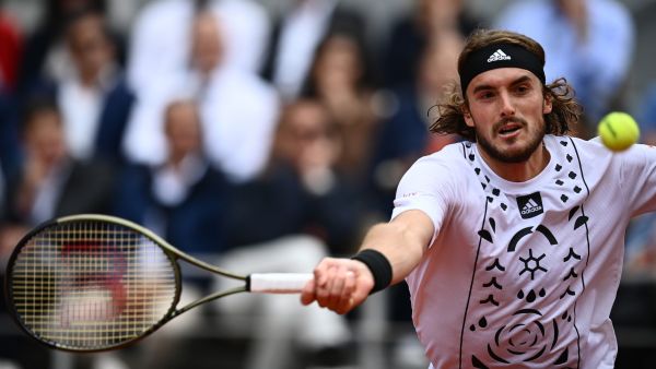 Greece's Stefanos Tsitsipas returns to Denmark's Holger Rune during their men's singles match on day nine of the Roland-Garros Open tennis tournament at the Court Philippe-Chatrier in Paris on May 30, 2022. (Photo by Christophe ARCHAMBAULT / AFP)