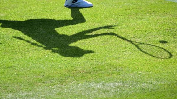 The shadow of Belgium's Elise Mertens is pictured as she returns the ball to Colombia's Camila Osorio during their women's singles tennis match on the first day of the 2022 Wimbledon Championships at The All England Tennis Club in Wimbledon, southwest London, on June 27, 2022. (Photo by SEBASTIEN BOZON / AFP)