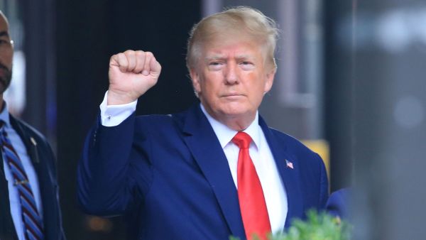 In this file photo taken on August 10, 2022 former US President Donald Trump raises his fist while walking to a vehicle outside of Trump Tower in New York City. (Photo by STRINGER / AFP) Donald Trump