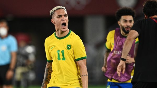 Brazil's Antony celebrates after teammate Malcom Filipe scored against Spain during the Tokyo 2020 Olympic Games football competition men's gold medal match at Yokohama International Stadium in Yokohama, Japan, on August 7, 2021. (Photo by Anne-Christine POUJOULAT / AFP)