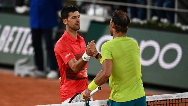 Spain's Rafael Nadal (R) shakes hands with Serbia's Novak Djokovic (L) after winning at the end of their men's singles match on day ten of the Roland-Garros Open tennis tournament at the Court Philippe-Chatrier in Paris early June 1, 2022. (Photo by Christophe ARCHAMBAULT / AFP)