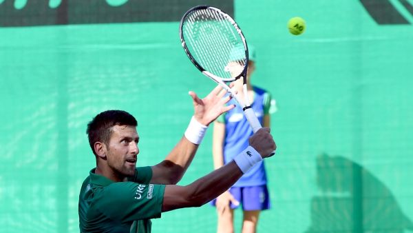 Serbian tennis player Novak Djokovic returns the ball during an exhibition match, organised to mark the opening of a tennis court at the "Archaeological park of the Bosnian pyramid" near Visoko, north of Sarajevo, on July 13, 2022. (Photo by ELVIS BARUKCIC / AFP)