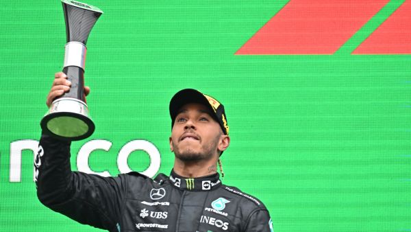 Mercedes' British driver Lewis Hamilton celebrates with the trophy on the podium after the Formula One Hungarian Grand Prix at the Hungaroring in Mogyorod near Budapest, Hungary, on July 31, 2022. (Photo by Attila KISBENEDEK / AFP)