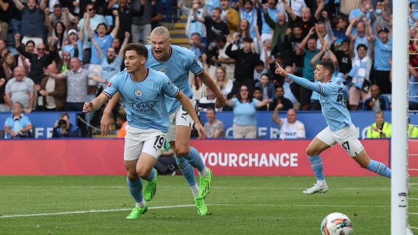 Manchester City's Argentinian striker Julian Alvarez (L) celebrates after scoring his team first goal during the English FA Community Shield football match between Liverpool and Manchester City at the King Power Stadium in Leicester on July 30, 2022. (Photo by Nigel Roddis / AFP)