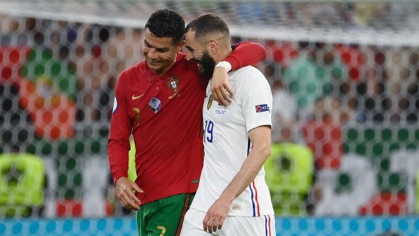 Portugal's forward Cristiano Ronaldo and France's forward Karim Benzema walk together off the pitch in half-time of the UEFA EURO 2020 Group F football match between Portugal and France at Puskas Arena in Budapest on June 23, 2021. / AFP / POOL / FRANCK FIFE
