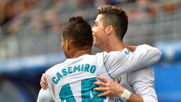 Real Madrid's Portuguese forward Cristiano Ronaldo (R) celebrates with Real Madrid's Brazilian midfielder Casemiro after scoring a goal during the Spanish league football match between Eibar and Real Madrid at the Ipurua stadium in Eibar on March 10, 2018. (Photo by ANDER GILLENEA / AFP)