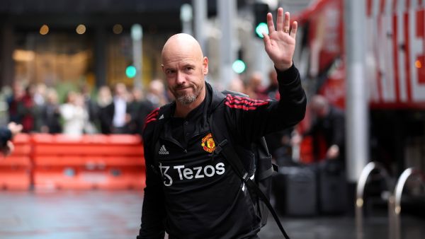 Manchester United's manager Erik Ten Hag ways as he walks towards the hotel upon team arrival in Melbourne on July 13, 2022, ahead of their exhibition football match against Melbourne Victory. (Photo by Martin KEEP / AFP)