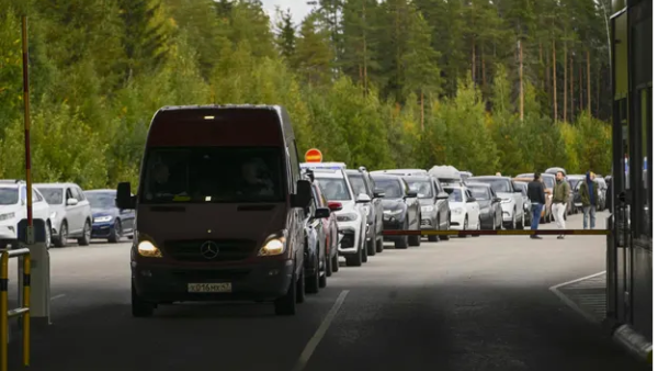 Cars from Russia queue at the border into Finland, (Olivier Morin/AFP/Getty Images) Russians seek to flee before the draft