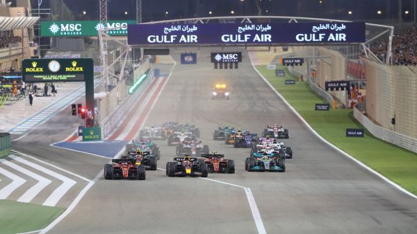 Ferrari's Monegasque driver Charles Leclerc (L) leads at the start of the Bahrain Formula One Grand Prix at the Bahrain International Circuit in the city of Sakhir on March 20, 2022. (Photo by Giuseppe CACACE / AFP)