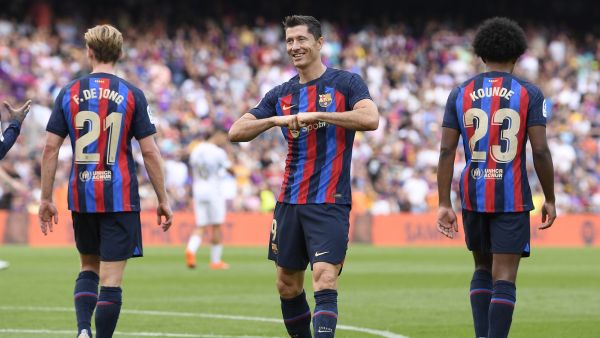 Barcelona's Polish forward Robert Lewandowski celebrates scoring his team's third goal during the Spanish League football match between FC Barcelona and Elche CF at the Camp Nou stadium in Barcelona on September 17, 2022. (Photo by Josep LAGO / AFP)