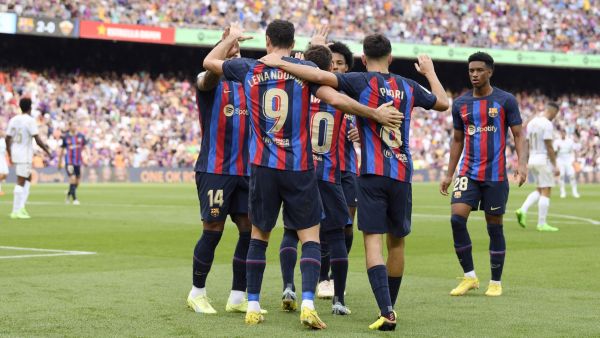 Barcelona's Polish forward Robert Lewandowski celebrates with teammates after scoring his team's third goal during the Spanish League football match between FC Barcelona and Elche CF at the Camp Nou stadium in Barcelona on September 17, 2022. (Photo by Josep LAGO / AFP)