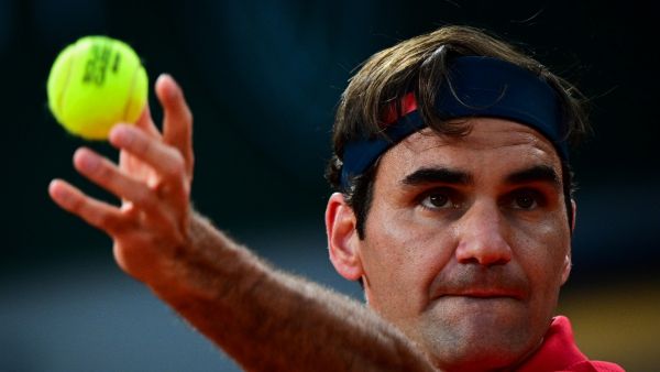Switzerland's Roger Federer serves the ball to Germany's Dominik Koepfer during their men's singles third round tennis match on Day 7 of The Roland Garros 2021 French Open tennis tournament in Paris on June 5, 2021. (Photo by MARTIN BUREAU / AFP)