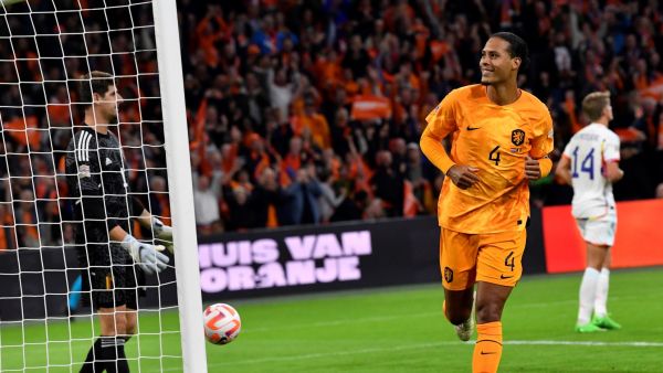 Netherlands' defender Virgil van Dijk (R) celebrates after scoring a goal during the UEFA Nations League's League A Group 4 football match between The Netherlands and Belgium, at Johan Cruyff ArenA in Amsterdam on September 25, 2022. (Photo by JOHN THYS / AFP)