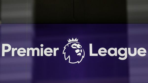 The logo is pictured through a glass window at the headquarters of the English Premier League in London on March 13, 2020. / AFP / Isabel Infantes