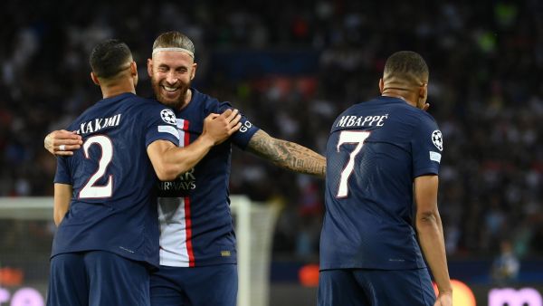 Paris Saint-Germain's French forward Kylian Mbappe (R) celebrates scoring the 2-0 goal with Paris Saint-Germain's Moroccan defender Achraf Hakimi (L) and Paris Saint-Germain's Spanish defender Sergio Ramos (C) during the UEFA Champions League Group H first leg football match between Paris Saint-Germain (PSG) and Juventus at Parc des Princes Stadium in Paris, on September 6, 2022. (Photo by FRANCK FIFE / AFP)