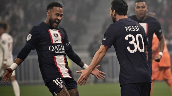 Paris Saint-Germain's Argentine forward Lionel Messi (R) is congratulated by Paris Saint-Germain's Brazilian forward Neymar after scoring a goal during the French L1 football match between Olympique Lyonnais (OL) and Paris Saint-Germain (PSG) at The Groupama Stadium in Decines-Charpieu, central-eastern France, on September 18, 2022. (Photo by Olivier CHASSIGNOLE / AFP)